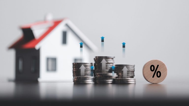 stacks of coins and model house with percentage symbol for increasing interest rates. interest rate financial and mortgage rates. Icon percentage symbol and arrow pointing up. home price or increase.